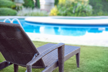 Canvas Print - Comfortable sun lounger near swimming pool at resort