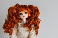 A Doll With Lush Red Hair In An Antique Dress