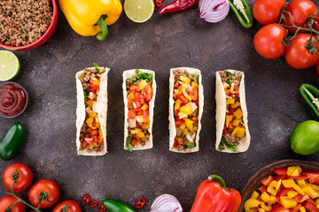 Mexican tacos with vegetables and meat. Ingredient for cooking tacos al pastor on concrete background. Top view