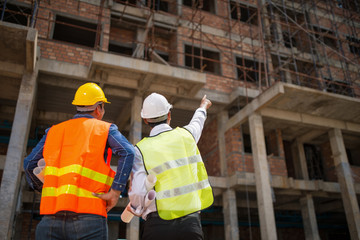 Wall Mural - Construction engineers discussion with architects at construction site or building site of highrise building