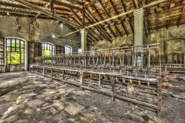  Old weaving looms and spinning machinery at an abandoned factory