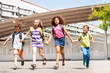 © Sergey Novikov - Excited kids run, hold hands near school building