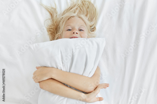 Funny Little Girl With Blonde Hair And Blue Eyes Having Fun In