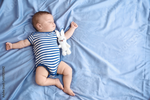 Fototapeta Cute little baby sleeping on bed