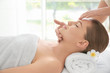 © Africa Studio - Young woman enjoying of facial massage in spa salon
