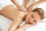Young beautiful woman having massage in spa salon