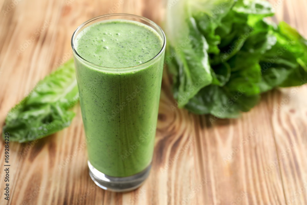 Glass of fresh vegetable smoothie on wooden table
