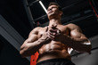 © antondotsenko - Caucasian handsome fitness model training in the gym. Man on diet flexing muscles