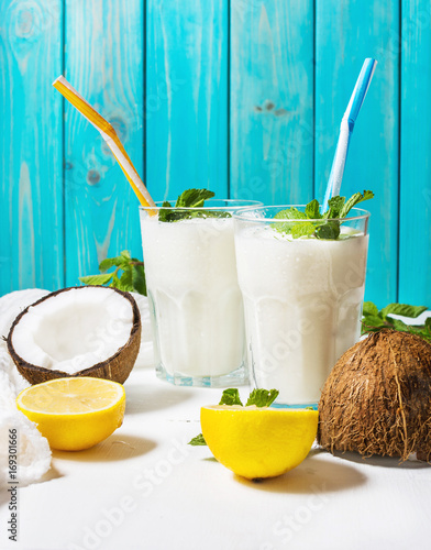 Cuadros en Lienzo Coconut vegan milk coctail in glass on wooden background