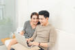© makistock - Happy asian couple in love surfing on tablet at home