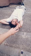 Hombre joven tumbado en el suelo extendiendo la mano para tocar a alguien