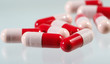 Heap of red and pink antibiotics capsule