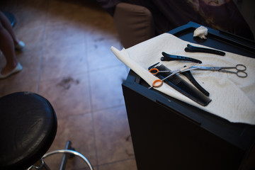 Close up on Scissors and comb in the hairdresser