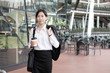© ijeab - Business woman walking drinking coffee.