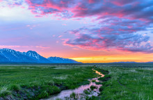 Sunset Mountain Meadow - Colorful Spring Sunset At A Green Mountain Field With A Winding Stream Near Mormon Row Historic District In Grand Teton National Park, Wyoming, USA.