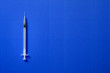 Medical syringe. Syringe for insulin on a blue background