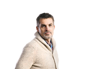 Mature hipster man in beige sweater. Studio shot, isolated.