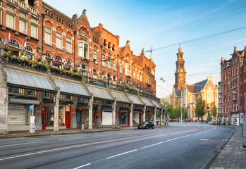 Poster - Amsterdam street with cathedral Westerker at sunrise, Netherlands