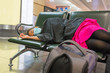 © Quang - Asian female fall asleep on bench with her luggage