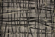 Contemporary, abstract painting of lines. Shades of gray, black, and beige / cream paint on canvas. Large, close up photo.