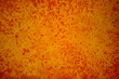 Large, close up photo of a simple, grungy background. Hand painted with vibrant shades of orange on canvas.