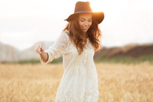 Happy Smiling Woman With Long Hair In Hat Walking