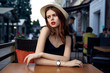 © SHOTPRIME STUDIO - A woman is sitting in a cafe on the terrace