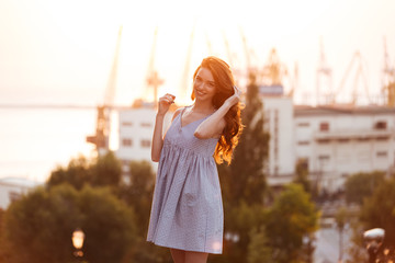 Sticker - Beauty Young Ginger girl in dress posing on the sunset