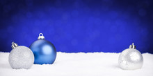 Silver And Blue Christmas Baubles On Snow, Blue Background