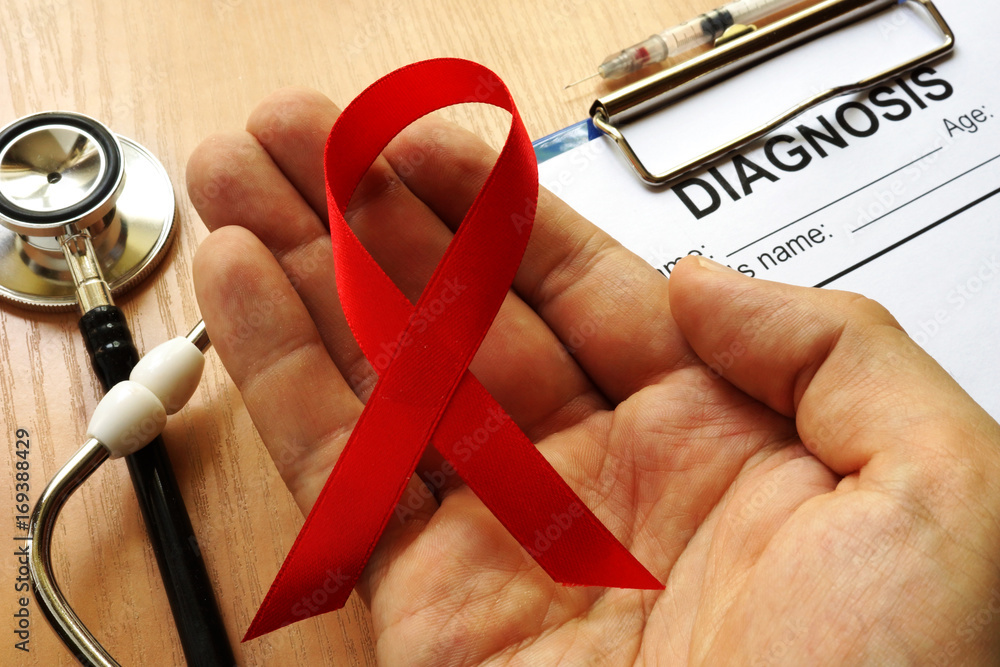 Symbol of HIV/AIDS. Red awareness ribbon. - obrazy, fototapety, plakaty 