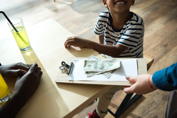 father and son paying bill