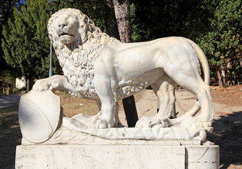 Wall Mural - Ancient roman lion sculpture in park, Rome, Italy