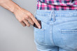© aldarinho - The man's hand pulls purse out of the back pocket