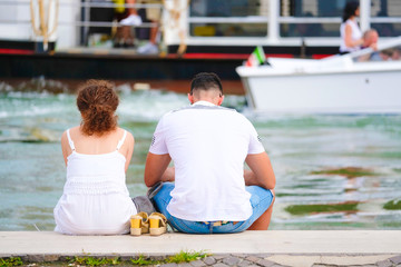 Poster - Venice, Italy - July, 28, 2017: couple sits near the Channel in Venice, Italy