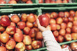 © santypan - Beautiful woman choosing apples in supermarket.