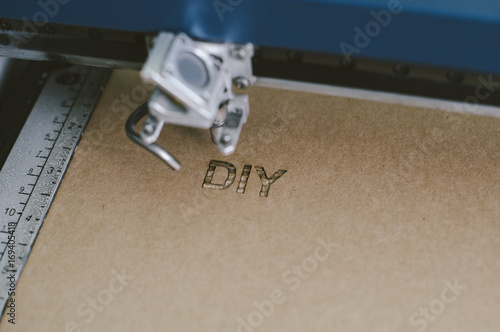 Fotografía Laser engraving DIY (Do It Youfself) word on recycle cardboard
