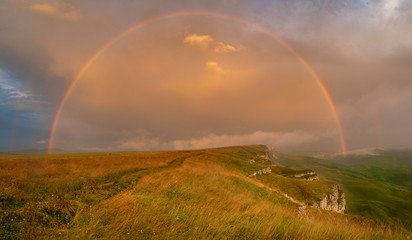 Poster - rainbow on a high plateau in the evening after the rain