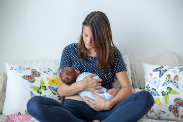 Poster - Young mother breastfeeding  her newborn baby boy