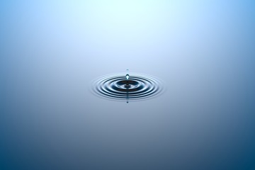 water drop falling into water surface
