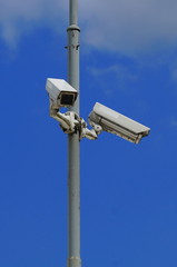 Security cameras on blue sky background - insecam