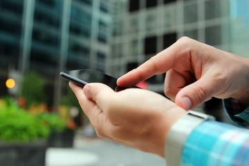 man using a   modern mobile phone outside