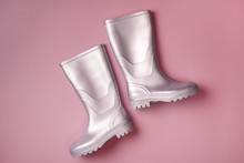 From Above Shot Of Trendy Silver Rain Boots On Pink Background. Top View. Flat Lay,