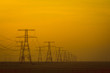 Power Lines crossing the desert in  the sunset