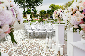 Wall Mural - Look from the wedding altar at path covered with petals and lying between rows of white chairs