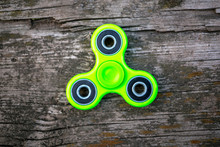 Green Spinner On A Wooden Background