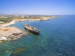 Naklejka na meble Aerial view of abandoned ship wreck EDRO III in Pegeia, Paphos, Cyprus. The rusty shipwreck is stranded on Peyia rocks at kantarkastoi sea caves, Coral Bay, Pafos, standing at an angle near the shore.