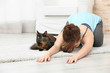 © Africa Studio - Young beautiful woman with cat practicing yoga pose at home