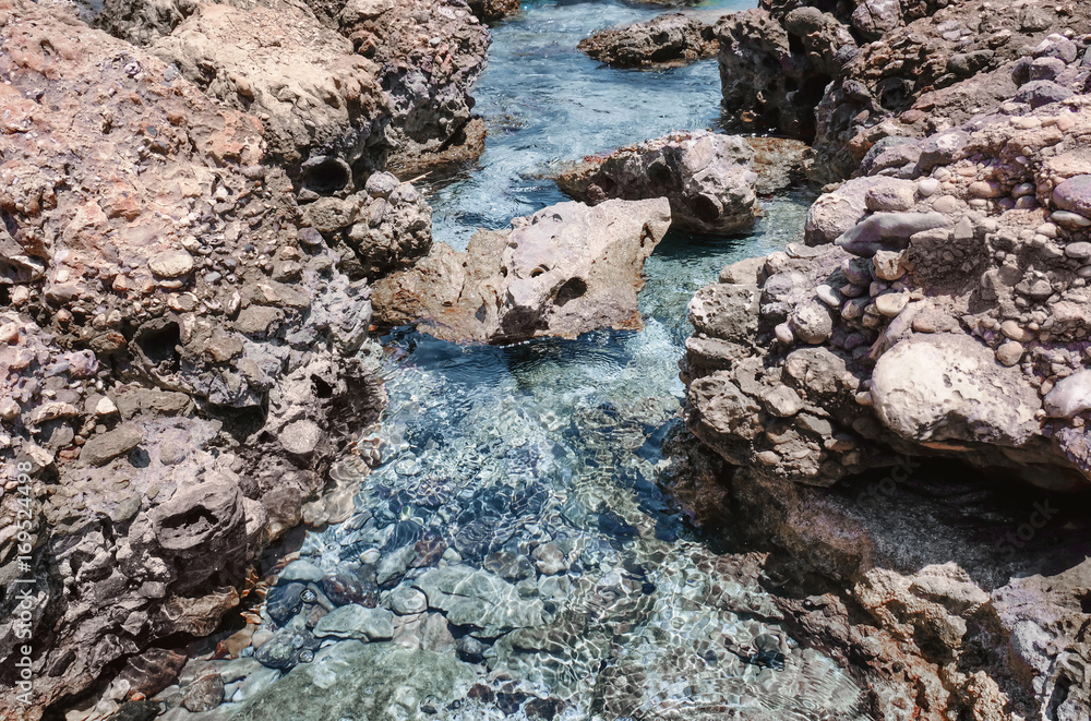 Sea coast with rocks on sunny day