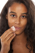 © vladimirfloyd - A young dark-skin girl remove her makeup on white background