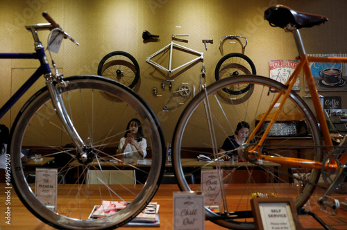 Customers Sit Inside A Bicycle Cafe Wheeler's Yard Cafe In 